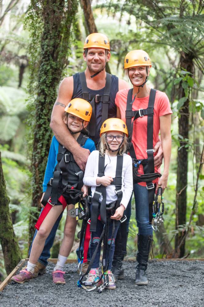 Guest on the zipline canopy tour flying through native forest at Driving Creek.